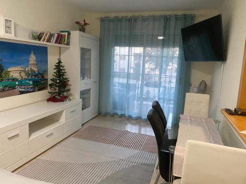 a dining room with a table and a window at Playas de cabo in Retamar
