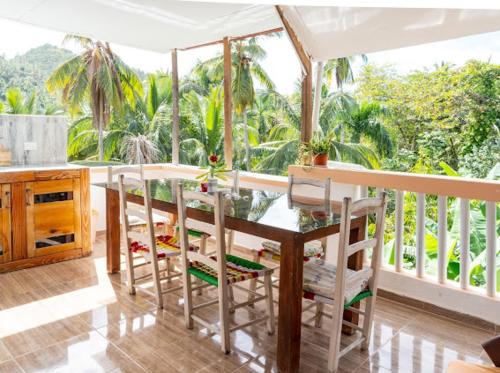 a kitchen with a table and chairs and a balcony at Casa Mariana in Las Terrenas