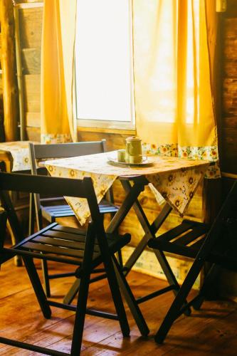 a table and a chair with a cup on it at Sitio Holistico Natureza Sanadora in Morro Reuter