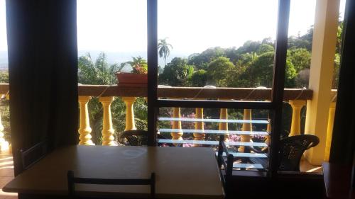 a table and chairs on a balcony with a view at La Princesa Hotel in San Isidro