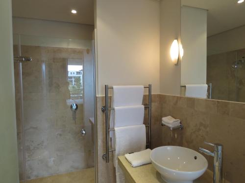 a bathroom with a sink and a shower at 202 Kylemore A Waterfront Marina in Cape Town