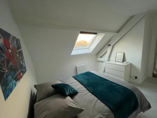 a small bedroom with a bed with a window at Family Disney coconing à 10 minutes du Parc in Coupvray