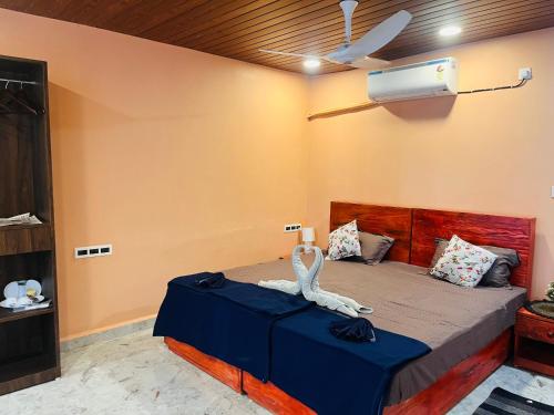 a bedroom with a bed with a ceiling fan at Tejas Beach View Stay Talpona in Canacona