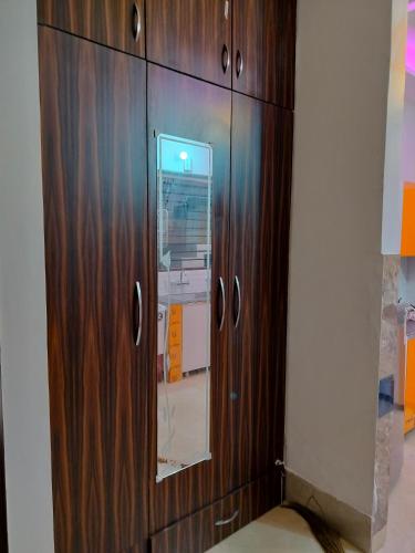 a wooden cabinet with a mirror in a room at Villa Elysian Park-1483 in Lāndrān