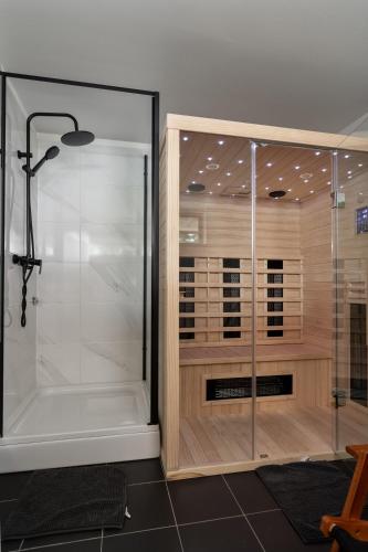 a shower with a glass door in a bathroom at Casa Luna in Ravna Gora