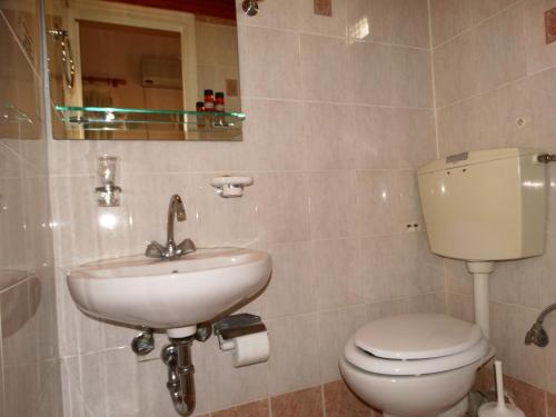 a bathroom with a toilet and a sink at Akrotainaritis Rooms in Gerolimenas