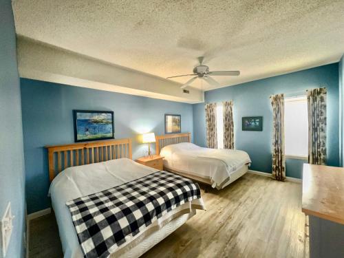 a bedroom with two beds and a ceiling fan at The Legends in Myrtle Beach