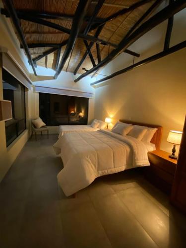 a large bedroom with a large white bed in it at Monteverde Best Inn - HOTEL in Tenza