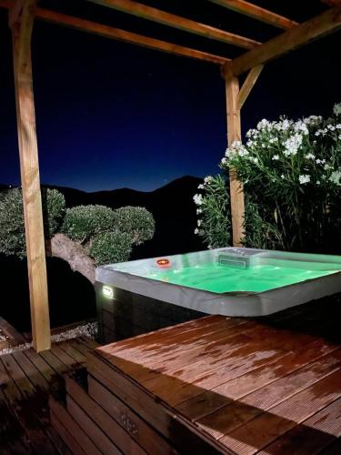 a bath tub sitting on a deck at night at Casa da Saudade in Ferreira do Zêzere