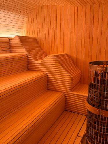 a sauna with wooden floors and steps in it at Wellness Penzion Zora Family in Tatranská Lomnica
