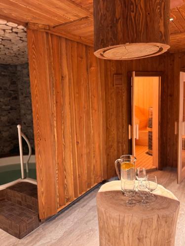 a room with a table with wine glasses on it at Wellness Penzion Zora Family in Tatranská Lomnica