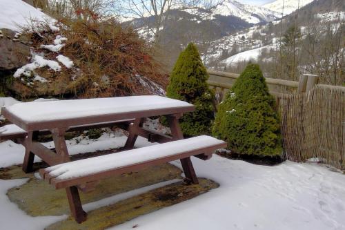 un banc recouvert de neige devant une clôture dans l'établissement Nice T2 with south facing terrace Flumet, à Flumet