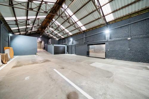 a large warehouse with a large empty parking lot at Loft36 in Herstal