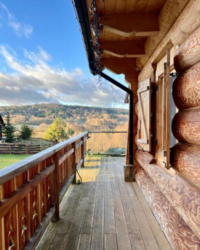 a porch of a cabin with a view of the mountains at Jurkowa Wola in Jureczkowa