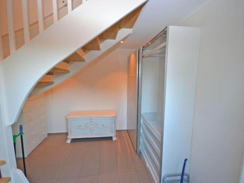 an attic room with a staircase and a blue cabinet at Nice apartment near the beach-By Traum in Mellbystrand