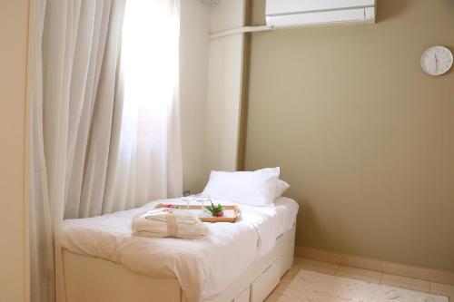 a bedroom with a bed with towels and a window at Queen Nefertari in Cairo