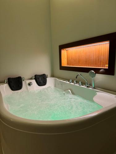 a bath tub filled with water in a bathroom at غصن الهدا in Al Hada