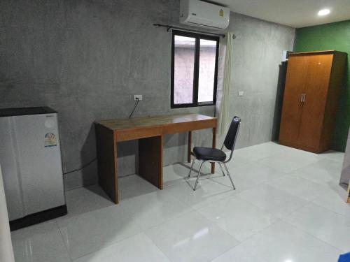 a desk in a room with a chair and a window at Ao Nang Khao Kaeo Resort in Ao Nang Beach