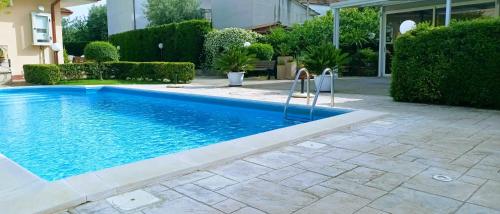 a swimming pool in a yard next to a house at La Residenza del Marchesato in Marano Marchesato