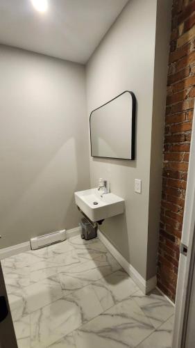 a bathroom with a sink and a mirror at ENTIRE BACHELOR UNIT EN-SUITE ACROSS FROM GOOGLE - br4 in Kitchener
