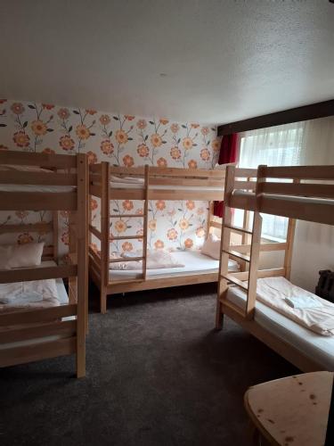 a room with three bunk beds and a window at Ferienheim Sorgenfrei in Sorge