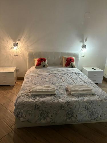 a bedroom with a large bed with two night stands at Affittacamere Valentina in Verona