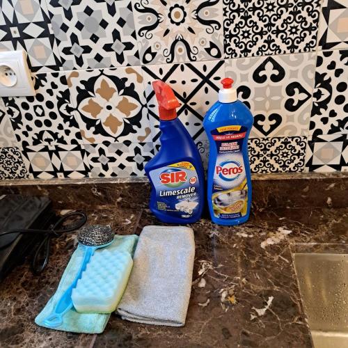 two bottles of cleaning products sitting on a counter at Appartement Neuf Excellent Rapport Qualité Prix CHU TANGER Forêt Diplomatique IBN Batouta in Daidatz