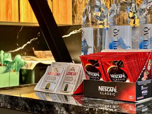 a counter top with two boxes of coffee on it at Qafqaz Rolling Bungalow HOT POOL in Gabala