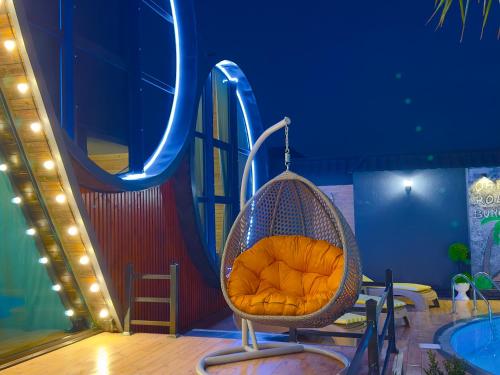 a swing on a slide next to a pool at Qafqaz Rolling Bungalow HOT POOL in Gabala