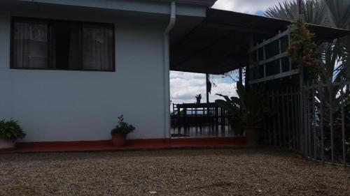 a white house with a gate and a fence at La Princesa Hotel in San Isidro