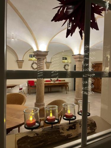 a room with a table with candles on it at Karlbacher Domizil Ferienwohnungen in Großkarlbach