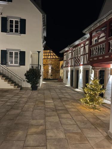 a courtyard at night with a christmas tree in the middle at Karlbacher Domizil Ferienwohnungen in Großkarlbach