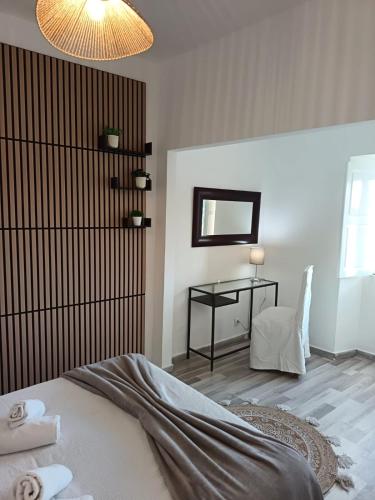 a bedroom with a bed and a mirror and a table at Vila Sunrise in Carvoeiro