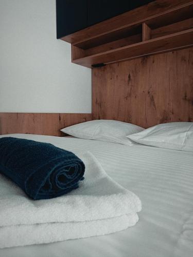 a blue pillow sitting on top of a bed at Stan na dan Nina Plus - Pale Centar in Pale