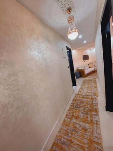 a hallway with a wall that is covered in tiles at Appartement Confortable Agadir in Agadir