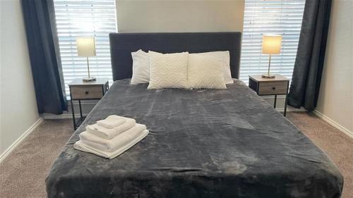 a bedroom with a large bed with towels on it at Spacious Family Value Retreat with Pool & Garage in Corpus Christi