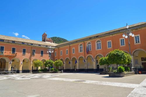 a large orange building with trees in a courtyard at Studio Paola - Levanto in Levanto