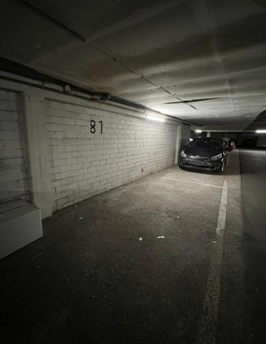 a parking garage with a car parked in it at Luxury Loft with Rooftop & Jacuzzi in City Center in Düsseldorf