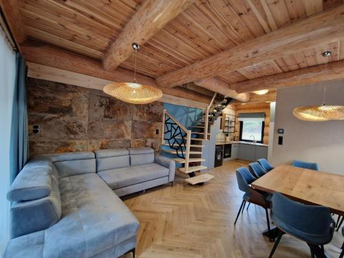 a living room with a couch and a table at Chata Braci Warchały in Warchały
