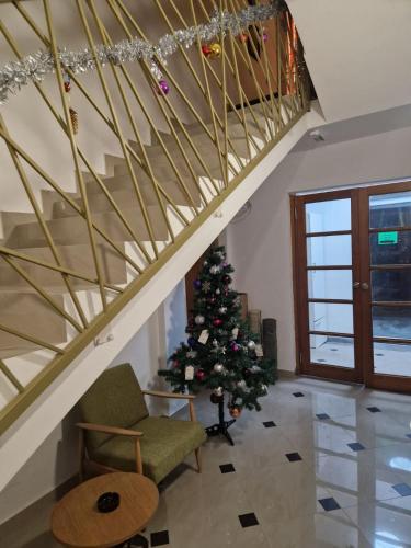 a christmas tree in a living room with a staircase at SMEŠTAJ SOLARIS kod Aqua Parka SUPERIOR & FAMILY Apartments in Soko Banja