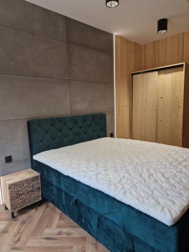 a bedroom with a large bed in a room at Chata Braci Warchały in Warchały