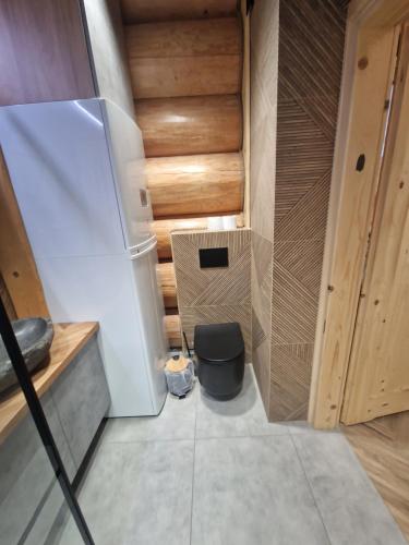 a small room with a refrigerator and a trash can at Chata Braci Warchały in Warchały