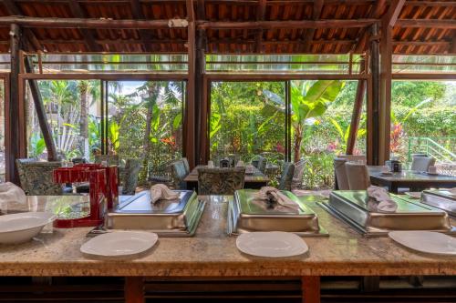 a table with four sinks in a room with windows at Hotel San Bada Resort & Spa in Manuel Antonio