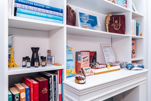 a book shelf filled with books and other items at Mauthaus Schönbrunn in Vienna