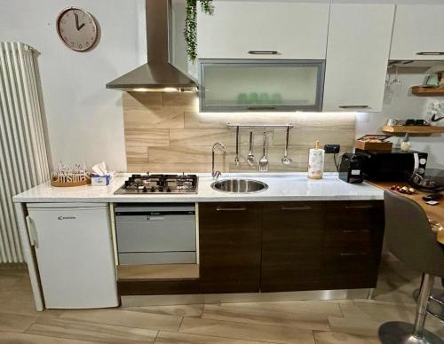 a kitchen with a sink and a stove at Casa Mirè in Savigliano