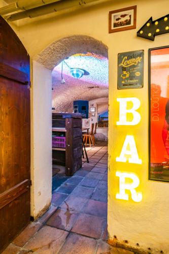 an entrance to a bar with a sign on a wall at Chalupa V Tajchách in Rokytnice nad Jizerou