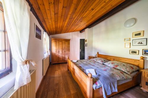 a bedroom with a bed and a wooden ceiling at Chalupa V Tajchách in Rokytnice nad Jizerou