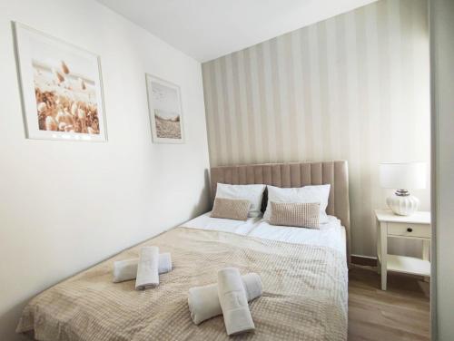a bedroom with a bed with two towels on it at A top-floor modern apartment Located 100 meters from the beach in Fuengirola