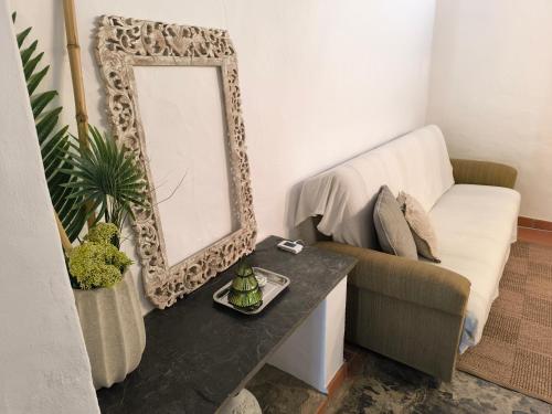a living room with a mirror and a couch at Sublime Village House in Monsaraz