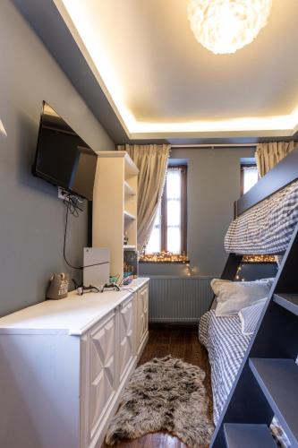 a room with a bed and a tv on a wall at Rock Dandy La Maison de l'Ours - Nymfaio in Nimfaíon